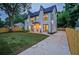A two-story modern farmhouse with stylish exterior lighting and freshly installed driveway at 2809 Glenwood Se Ave, Atlanta, GA 30317