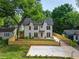 Charming two-story modern farmhouse with black accents, front yard, and driveway at 2809 Glenwood Se Ave, Atlanta, GA 30317