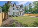Modern farmhouse with a manicured lawn, fresh landscaping, and newly installed wooden fence at 2809 Glenwood Se Ave, Atlanta, GA 30317