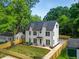 Charming two-story modern farmhouse with lush trees and a newly installed wooden fence at 2809 Glenwood Se Ave, Atlanta, GA 30317
