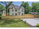 Stylish two-story home boasts a manicured lawn, fresh landscaping, and a black metal gate at 2809 Glenwood Se Ave, Atlanta, GA 30317