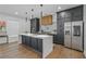 Modern kitchen featuring sleek dark cabinets, an island with a white countertop, and stainless steel appliances at 2809 Glenwood Se Ave, Atlanta, GA 30317