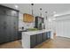 Modern kitchen with a waterfall island, wooden accents, and stainless steel appliances at 2809 Glenwood Se Ave, Atlanta, GA 30317