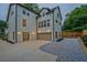 Rear exterior view featuring a two-car garage, gravel landscaping, and stylish outdoor lighting at 2809 Glenwood Se Ave, Atlanta, GA 30317