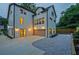 Rear exterior view featuring a two-car garage, gravel landscaping, and stylish outdoor lighting at 2809 Glenwood Se Ave, Atlanta, GA 30317