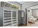 Bright walk-in closet featuring custom built-in shelving and a view to a comfortable seating area at 2809 Glenwood Se Ave, Atlanta, GA 30317