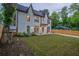 Charming new two-story home with a manicured lawn, driveway, and wood fence at 2809 Glenwood Se Ave, Atlanta, GA 30317