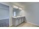Bathroom with a double sink vanity, a large mirror, and wood-look tile flooring at 321 Heavenly Hollow Pl, Mcdonough, GA 30253