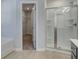Bright bathroom with a glass-enclosed shower and view into the walk-in closet with wire shelving at 321 Heavenly Hollow Pl, Mcdonough, GA 30253