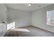 Bedroom featuring neutral carpet, gray walls, and a window for natural lighting at 321 Heavenly Hollow Pl, Mcdonough, GA 30253