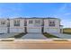New townhomes featuring symmetrical design, grey shutters, concrete driveway, and manicured landscaping at 321 Heavenly Hollow Pl, Mcdonough, GA 30253