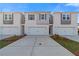 New townhomes with garage, grey accents, landscaping, and symmetrical design under clear sky at 321 Heavenly Hollow Pl, Mcdonough, GA 30253