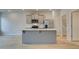 Stylish kitchen with stainless steel appliances, grey cabinets, spacious island, and wood-look floors at 321 Heavenly Hollow Pl, Mcdonough, GA 30253