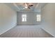 Spacious main bedroom with neutral carpet, a ceiling fan, and windows for natural light at 321 Heavenly Hollow Pl, Mcdonough, GA 30253
