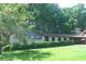 Charming brick home featuring a well-manicured lawn and a convenient carport at 4747 Darlene Way, Tucker, GA 30084