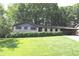 Charming brick home featuring a well-manicured lawn and a convenient carport at 4747 Darlene Way, Tucker, GA 30084