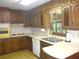 Traditional kitchen featuring ample wood cabinets and a bright window view at 4747 Darlene Way, Tucker, GA 30084