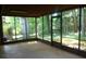 Spacious screened-in porch offering a tranquil view of the wooded backyard at 4747 Darlene Way, Tucker, GA 30084