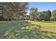 Aerial view showcases the home's mature landscaping and spacious backyard and covered patio with outdoor dining at 160 Isleworth Way, Fayetteville, GA 30215