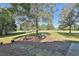 Backyard with trees overlooking a lawn area and outdoor table at 160 Isleworth Way, Fayetteville, GA 30215