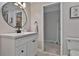 Bathroom featuring a white vanity with a round mirror and a doorway leading to another room at 160 Isleworth Way, Fayetteville, GA 30215
