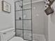 Shower stall featuring tiled walls, a black-framed glass enclosure, and stylish fixtures at 160 Isleworth Way, Fayetteville, GA 30215