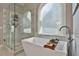 Elegant bathroom featuring a freestanding tub, glass shower, and stylish fixtures at 160 Isleworth Way, Fayetteville, GA 30215
