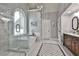 Elegant bathroom featuring marble shower, soaking tub, and vanity with dark wood cabinets at 160 Isleworth Way, Fayetteville, GA 30215