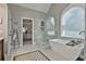 Elegant bathroom featuring a freestanding tub, glass shower, and stylish fixtures at 160 Isleworth Way, Fayetteville, GA 30215