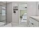 Bright bathroom featuring a glass-enclosed shower and vanity, with a glimpse into the adjacent bedroom at 160 Isleworth Way, Fayetteville, GA 30215