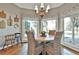 Inviting breakfast nook with a wood table, wicker chairs, chandelier, and windows providing natural light at 160 Isleworth Way, Fayetteville, GA 30215