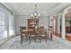 Elegant dining room with chandelier, hutch, and a large window, ideal for Gathering gatherings at 160 Isleworth Way, Fayetteville, GA 30215