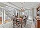 Bright dining room with a view of the staircase, featuring a wooden table and chandelier, perfect for gatherings at 160 Isleworth Way, Fayetteville, GA 30215