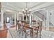 Open-concept dining room with hardwood floors, a view of the staircase, and a chandelier at 160 Isleworth Way, Fayetteville, GA 30215
