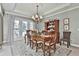 Traditional dining room with a wooden table, chairs, and large windows offering ample natural light at 160 Isleworth Way, Fayetteville, GA 30215