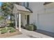 Side entrance to the garage with covered entry and trimmed shrubs at 160 Isleworth Way, Fayetteville, GA 30215
