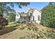Charming two-story home with stucco exterior, stone accents and mature landscaping on a sprawling lawn at 160 Isleworth Way, Fayetteville, GA 30215