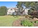 Charming two-story home with stucco exterior, stone accents and mature landscaping on a sprawling lawn at 160 Isleworth Way, Fayetteville, GA 30215