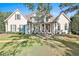 Traditional home featuring a manicured lawn, covered entry and decorative shutters at 160 Isleworth Way, Fayetteville, GA 30215