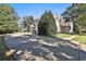 Exterior view of home featuring mature landscaping and covered entry at 160 Isleworth Way, Fayetteville, GA 30215