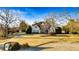 Desirable home with a manicured lawn, mature trees, and a charming covered front porch at 160 Isleworth Way, Fayetteville, GA 30215
