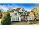 Elegant home with stone accents, arched windows, a covered porch, manicured landscaping and inviting curb appeal at 160 Isleworth Way, Fayetteville, GA 30215