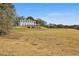 The beautiful clubhouse sits amidst a green golf course on a sunny day at 160 Isleworth Way, Fayetteville, GA 30215