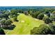 Scenic view of a meticulously maintained golf course with mature trees and manicured fairways at 160 Isleworth Way, Fayetteville, GA 30215