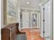 Light-filled hallway with hardwood floors, decorative accents and multiple entryways at 160 Isleworth Way, Fayetteville, GA 30215