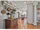 Hallway view leading to a bright kitchen with stainless steel appliances and a center island at 160 Isleworth Way, Fayetteville, GA 30215