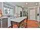Bright kitchen featuring white cabinets, a center island with marble countertop and stainless steel appliances at 160 Isleworth Way, Fayetteville, GA 30215
