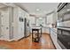 Well-lit kitchen featuring white cabinets, stainless steel appliances, and a wooden island at 160 Isleworth Way, Fayetteville, GA 30215
