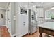 Modern kitchen with white cabinets, stainless steel appliances, and hardwood floors at 160 Isleworth Way, Fayetteville, GA 30215