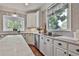 Kitchen featuring white cabinets, marble countertops, and stainless steel appliances at 160 Isleworth Way, Fayetteville, GA 30215